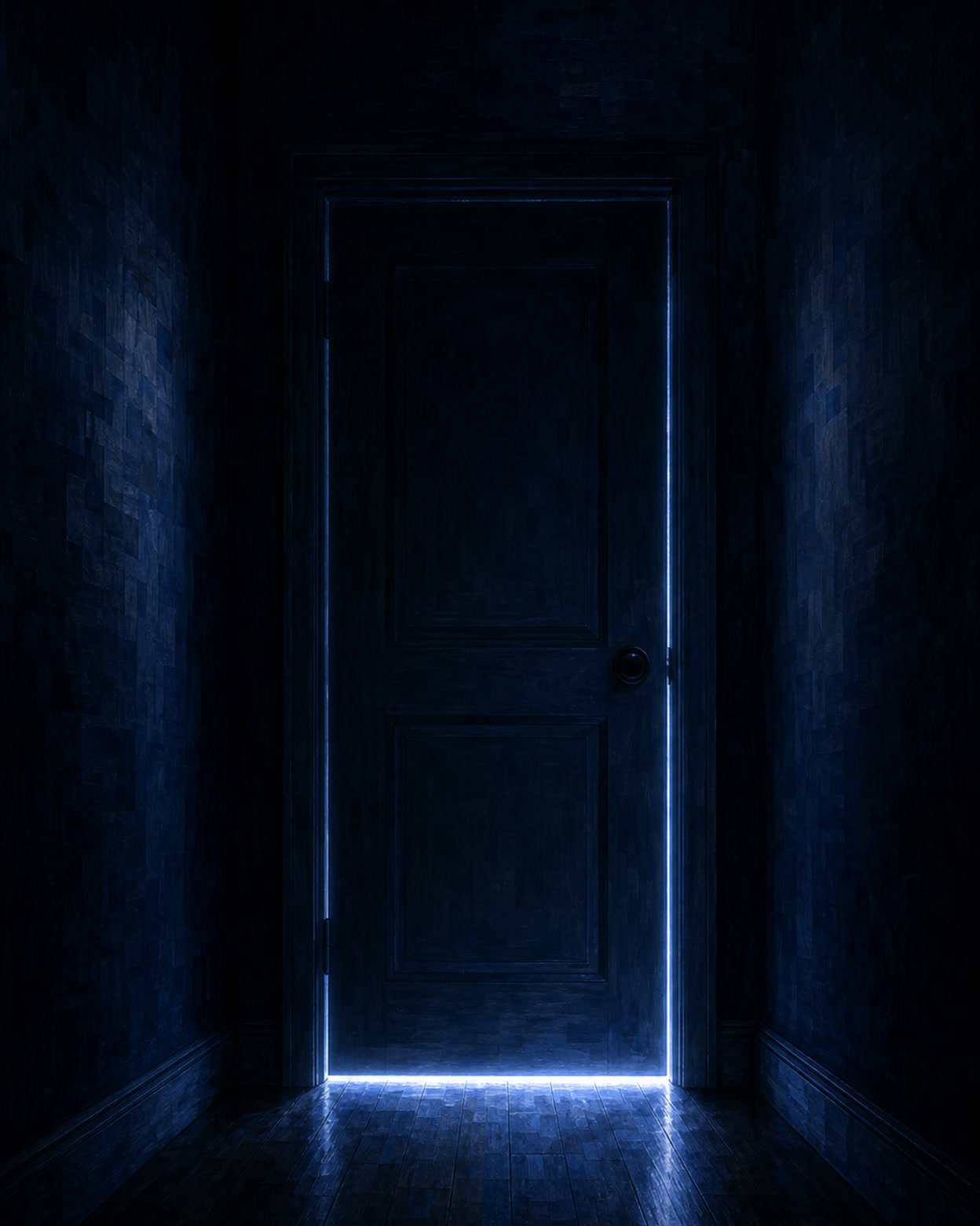 A dark night hallway with cold monitor light seeping out from under a closed child’s bedroom door